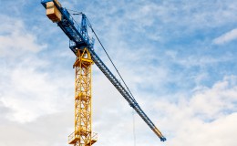 Yellow construction crane on blue sky